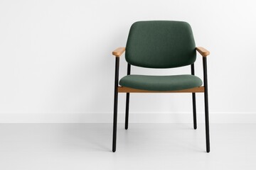 Contemporary front view of a stylish chair set against a plain white wall for interior or graphic use