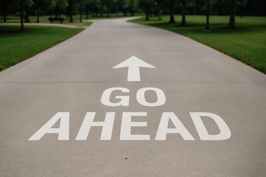 Proceed with the go-ahead sign on a paved road