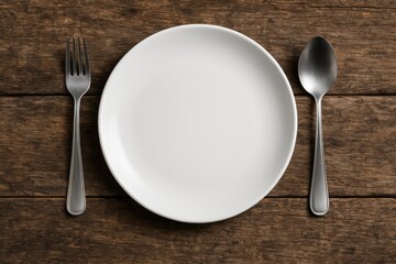 Empty plate with cutlery on rustic wooden surface, overhead shot