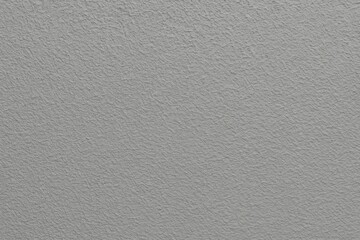 Textured gray stucco wall serving as a backdrop for the building