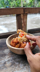 Tahu walik. Crispy browned tofu walik served in a natural wooden bowl with spicy chili sauce, with...
