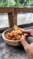 Tahu walik. Crispy browned tofu walik served in a natural wooden bowl with spicy chili sauce, with...