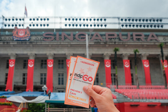 Singapore Jul04 2025 - Person holding balloted tickets for SG60 NDP National Day Parade preview in front of National Gallery Singapore. The annual event will be held at the Padang, across the museum