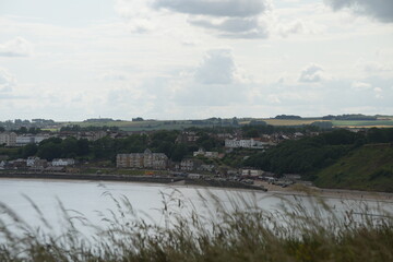 Beautiful coastal village view with beach and historic buildings in Filey, North Yorkshire, England.
