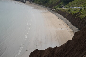 A serene sandy beach and clifftop view at low tide in Filey, North Yorkshire, England, capturing...