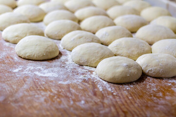 Homemade dough on wooden table at home.