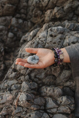 Close-up of female hands holding natural healing stones. Tools for energy balance, emotional...
