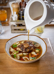 Oxtail soup being served in a restaurant
