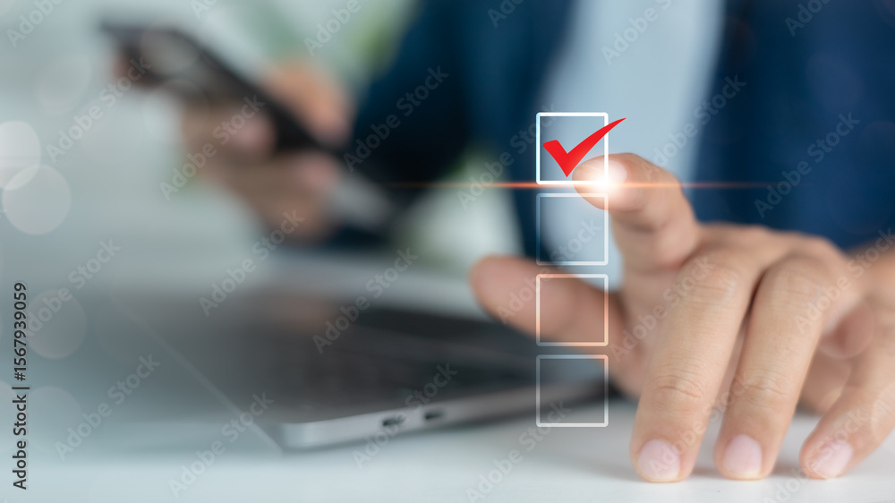 Poster close-up of hand touching digital checklist with red check mark icon on touchscreen, representing ta