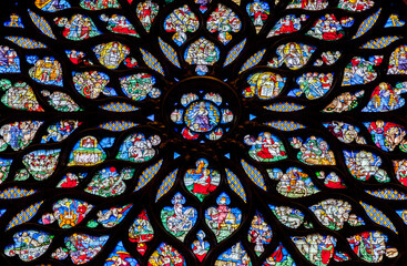 Stained glass rose window of Sainte-Chapelle, vibrant colors and intricate designs, interior
