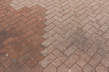 Texture of square paving tile. Pattern of red and brown sidewalk tiles in the street. Concrete pavers close up background.