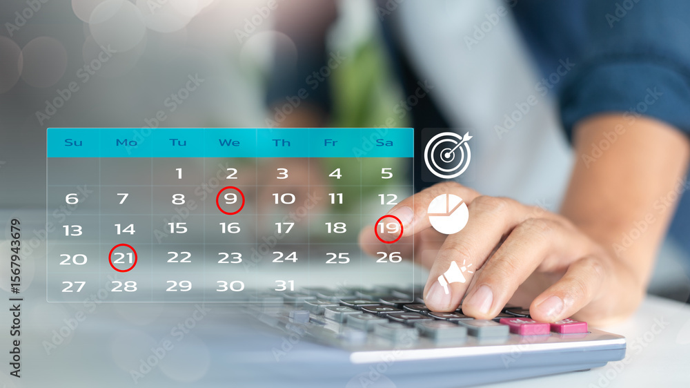 Aufkleber close-up of a hand using a calculator with a marked business calendar, showing project deadlines, fi