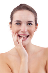 Obraz premium Woman laughing at the camera while touching her face, showing natural skin with facial imperfections, acne and pimples. Authentic female portrait before skincare or beauty treatment. Isolated on white
