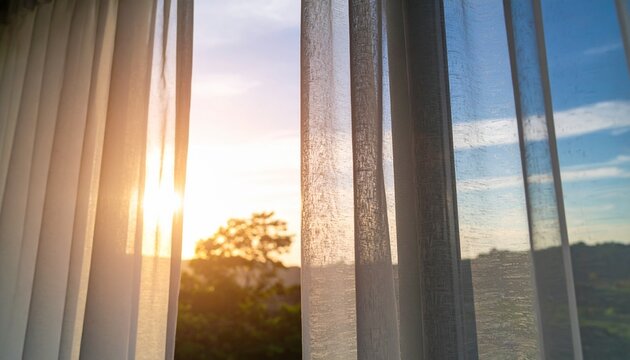 A window view captures soft light filtering through curtains, showing a clear blue sky. Emphasizes clean air and a fresh environment.