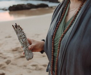 Close-up of female hands holding natural incense. Tools for ritual, energetic cleansing, and inner peace through aroma, intention, and mindful presence. Vintage tone. Soft focus, blurred