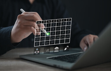 Business professional selecting a date on a digital calendar interface using a stylus on a laptop, representing smart scheduling, modern planning, and effective time management in business tasks.