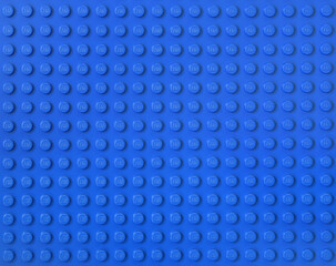 Naklejka premium Lego blue new baseplate with rows of round knots to assembly plastic bricks from popular toy brand. Editorial illustrative image of popular children plastic toy.
