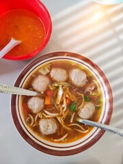 meatballs, traditional food on the table with a bowl of chili sauce