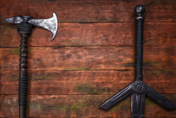 Old long medieval two handed knight warrior sword and battle axe on ancient table flat lay...