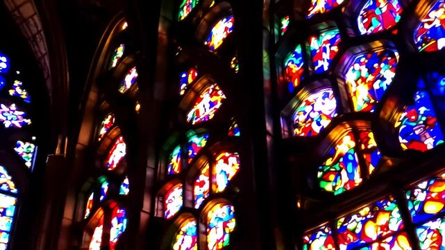 A close up of the Cathedral of Chartres' stained glass windows, focusing on the vibrant colors and intricate designs