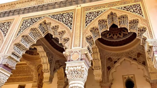 A close up of the detailed Islamic architecture in the Alhambra, focusing on the ornate carvings, arches, and tilework