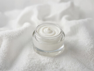 Cream jar on a white fluffy surface, perfect for beauty product visuals.