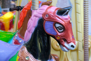 Vivid carousel horse adorned with jewels in a lively amusement park