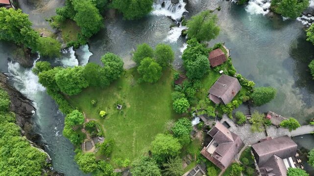Watermill village Rastoke on rivers Slunj and Korana. Charming village of Rastoke with waterfalls, wooden houses, rivers running through. Aerial view of fairy-tale spring location in heart of Croatia