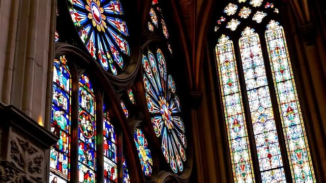 A close up of the stained glass windows of the Cathedral of Chartres, capturing the vibrant colors and delicate designs