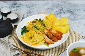 Egg noodle soup with red roasted pork and pork wontons Chinese food