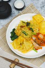Egg noodle soup with red roasted pork and pork wontons Chinese food