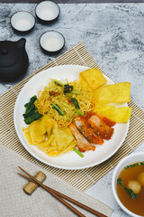 Egg noodle soup with red roasted pork and pork wontons Chinese food
