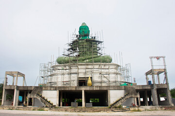 Renovate building sculpture carving Green buddha statue on ancient ordination hall and antique...