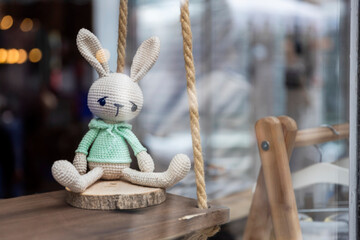 London, UK, 9 May 2025,  Hand-Knitted Crochet Rabbit Toy In A Shop Window.