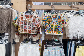 London, UK, 9 May 2025,  Flea market. Handmade Crochet Tops And Other Clothing Items On Display.