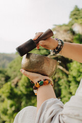 Close-up of female hands holding sound healing instruments. Tools for therapy, inner balance, and...