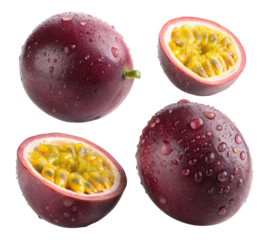 A close up view of passion fruits whole and cut in half with water droplets on a black background