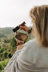 Close-up of female hands holding sound healing instruments. Tools for therapy, inner balance, and...