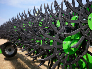 Close-up of a rotary harrow green color for processing an agricultural field.