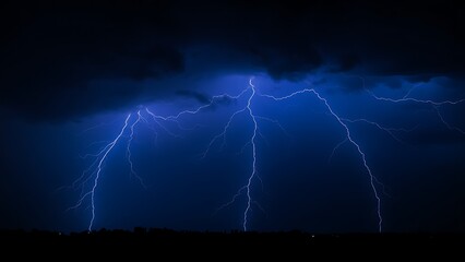 A dramatic lightning strike illuminates the dark stormy sky with electric blue brilliance.