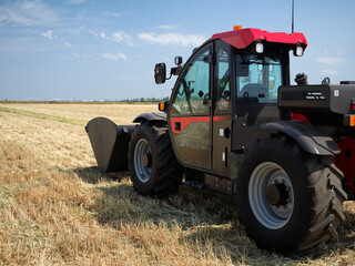 Agricultural excavator or loader with  bucket for field cleaning.