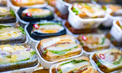 Pre-packaged sandwiches displayed in a commercial refrigerator