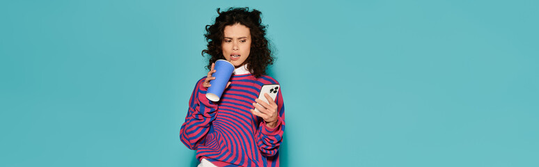 Young beautiful woman enjoys coffee while checking her smartphone in vibrant urban setting