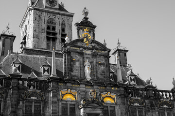 Black-and-white photo of Delft’s City Hall on Markt Square. Lady Justice, the Holland lion crest,...