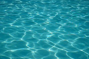 Fototapeta premium A close up shot of the light reflecting on the surface of a clear turquoise blue swimming pool water