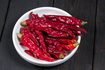 Dried red peppers in white bowl