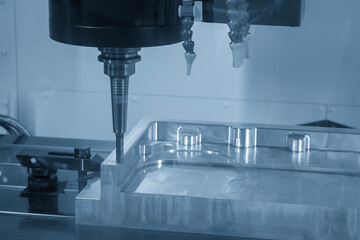 The CNC milling machine finish cut the aluminum housing parts with flat nose end mill tool in the...