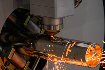 Close up scene the fiber laser cutting machine cut the stainless steel tube control by CNC program.