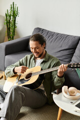Young man playing guitar at home, enjoying moment of creativity and relaxation in living room