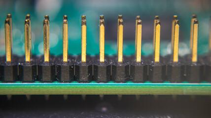Close-up of golden yellow Raspberry Pi pin connectors coated with gold plating. Enhances...